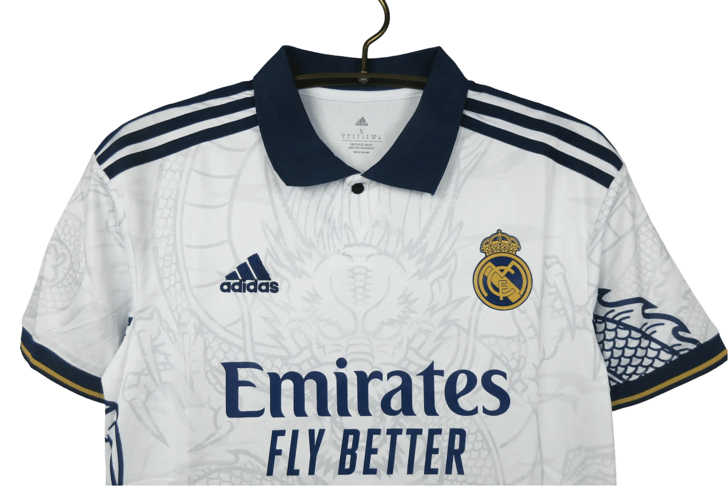 Jersey Real Madrid Dragon White Edition with intricate dragon artwork, inspired by the Real Madrid Kit with Dragon from 2014. High-quality fabric for comfort and durability.