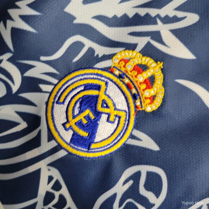 Real Madrid Dragon Jersey 2024 in a unique blue colorway, bringing back the iconic Dragon Real Madrid Shirt design with a modern touch. Available at GoatKits Store.