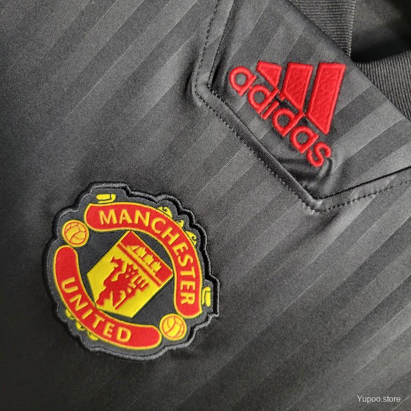 "Close-up of the intricate Black Icon Embroidery Logo on Manchester United jersey