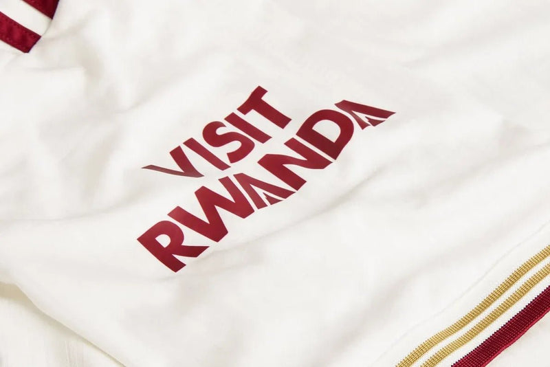 Arsenal third kit 25/26 polo collar detail with gold maroon stripes Adidas trefoil logo cannon crest close-up
