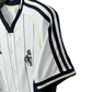 Real Madrid baseball shirt close-up showing black vertical pinstripes pattern and V-neck collar design perfect for travel and casual wear